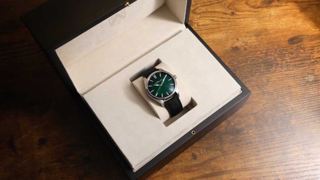H. Moser & Cie. Pioneer Centre Seconds Cosmic Green in presentation box on wood surface