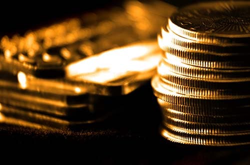 Pile,Of,Old,Coins,And,Bullion,With,Dark,Background