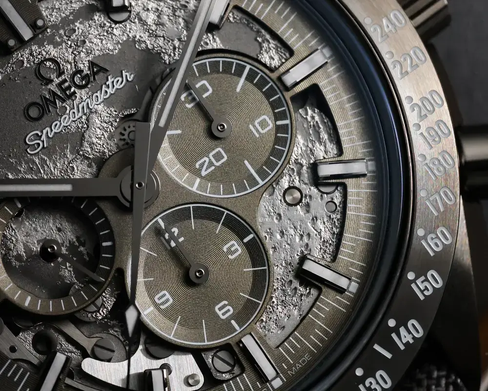 Laser-engraved grey dial of the Omega Speedmaster Dark Side of the Moon with moon surface texture