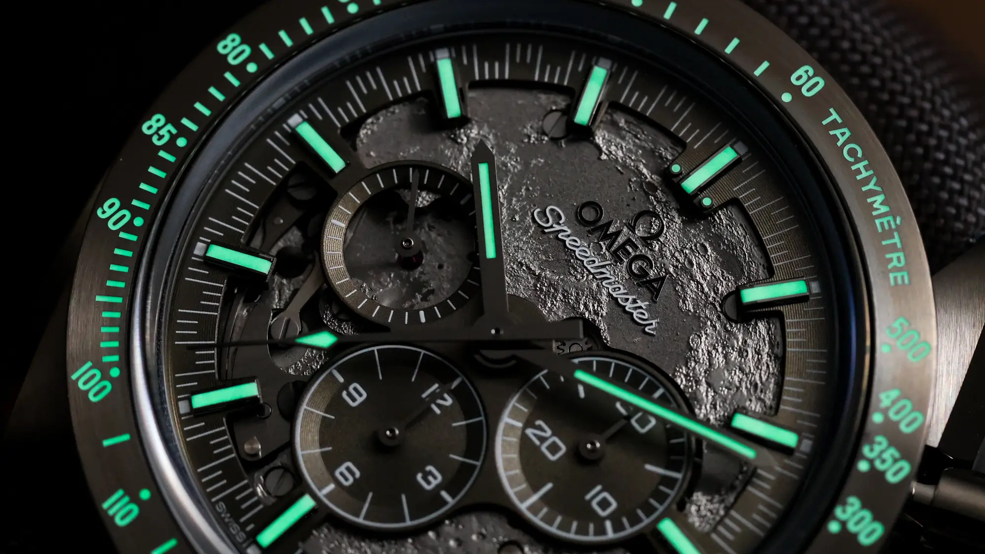 Omega Speedmaster Dark Side of the Moon glowing dial showing Super-LumiNova illumination