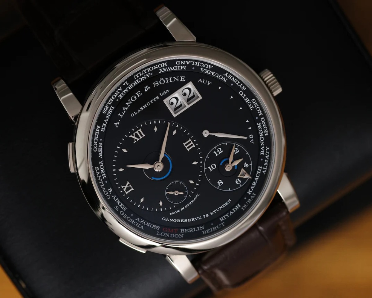 A. Lange & Söhne Lange 1 Time Zone 136.029 white gold watch displayed on leather case