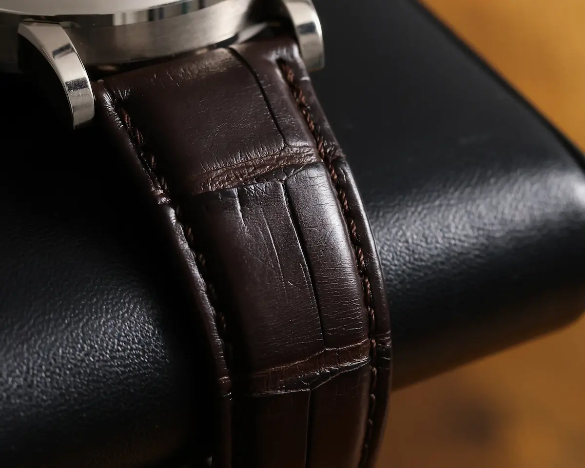 A. Lange & Söhne Lange 1 Time Zone 136.029 white gold watch displayed on leather case