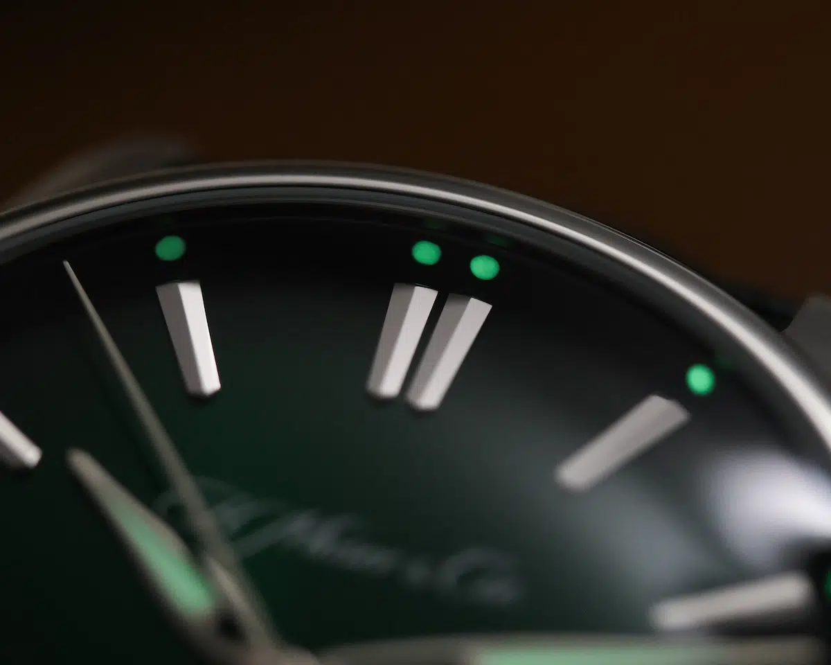 Lume view of H. Moser & Cie. Pioneer Centre Seconds Cosmic Green fumé dial in low light