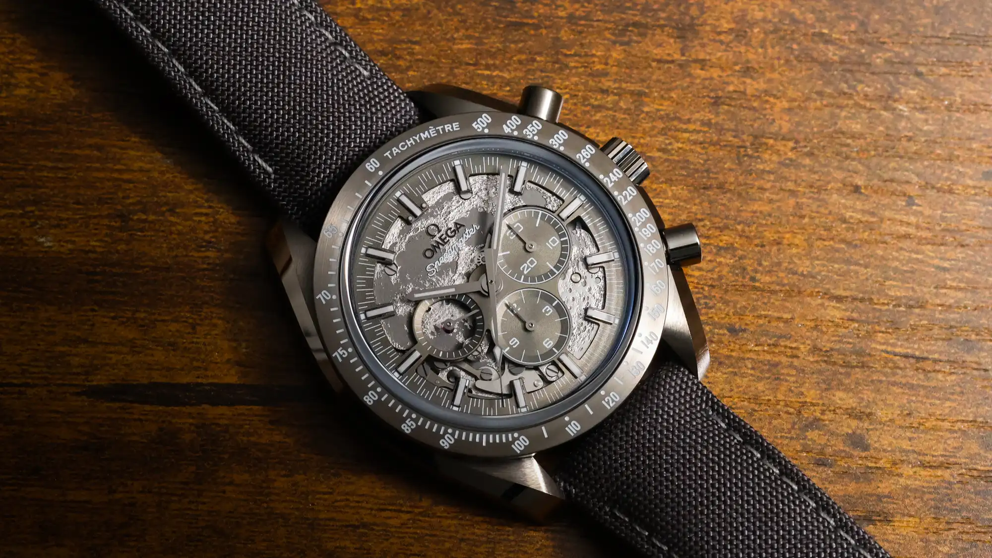 Omega Speedmaster Dark Side of the Moon full view highlighting grey rubber strap and ceramic case
