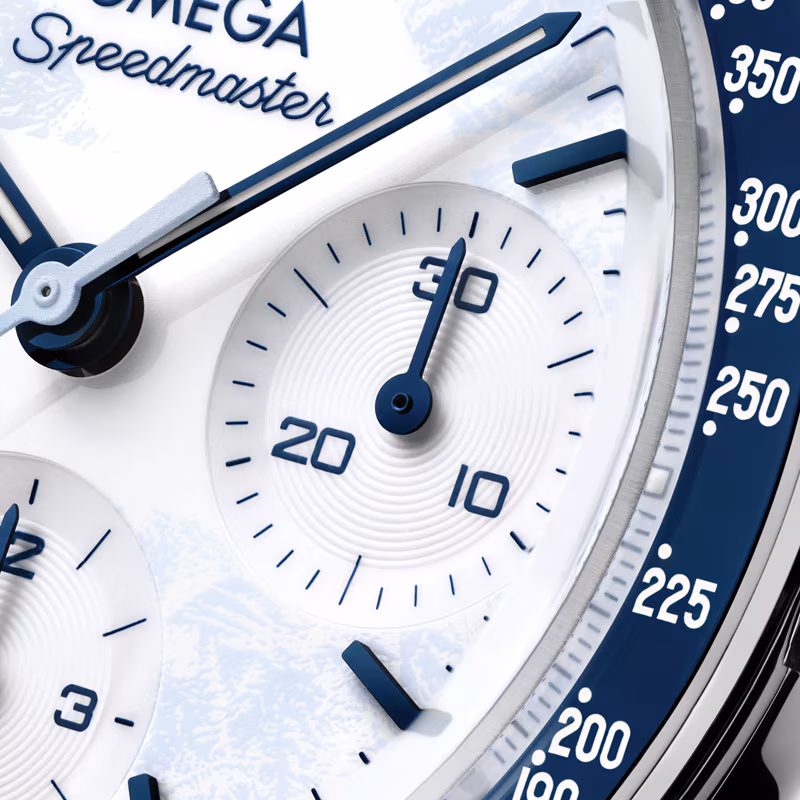 Close-up of blue ceramic bezel with white enamel tachymeter scale