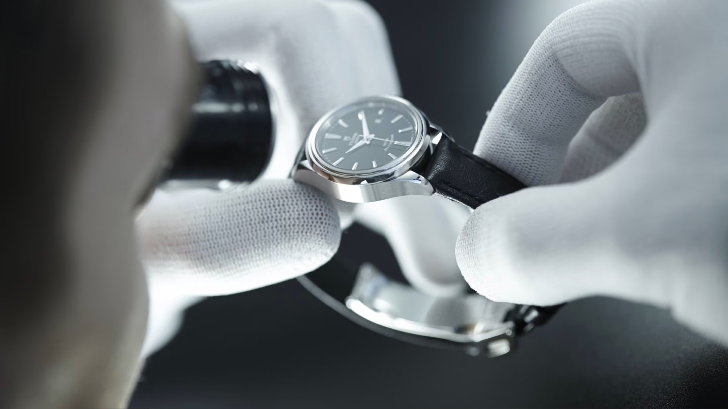 holdin tudor watch-servicing with white gloves