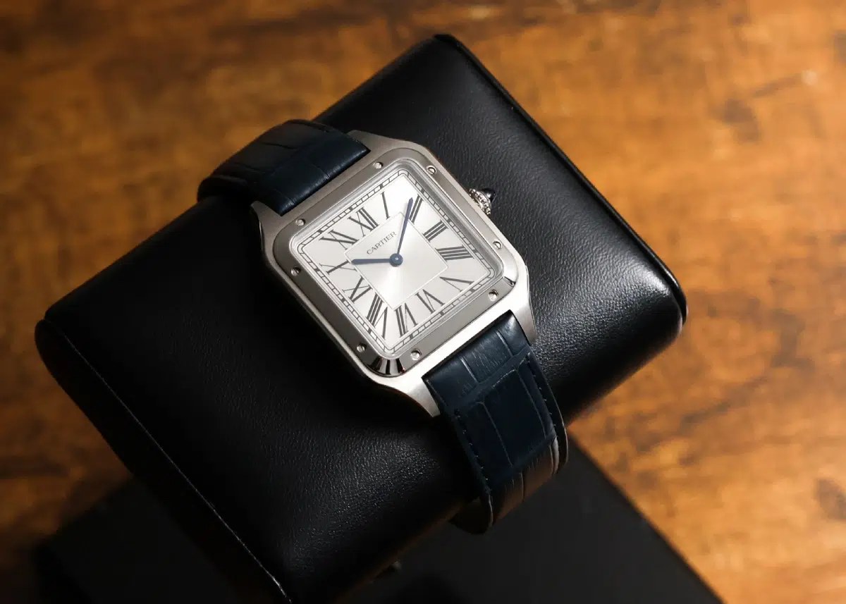 full Cartier Santos-Dumont CRWSSA0032 watch on leather box with warm background