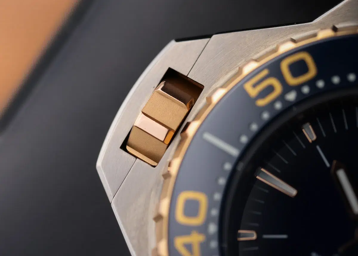 Close-up of Omega Seamaster Ploprof bezel with blue and gold accents