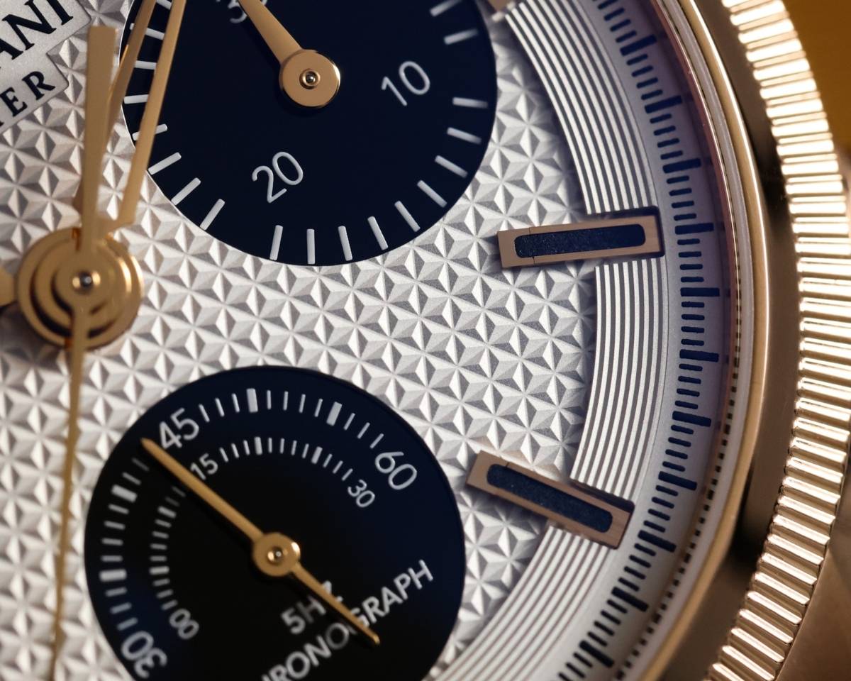 Macro detail of Parmigiani Tondagraph GT chronograph hands and Clou Triangulaire dial texture