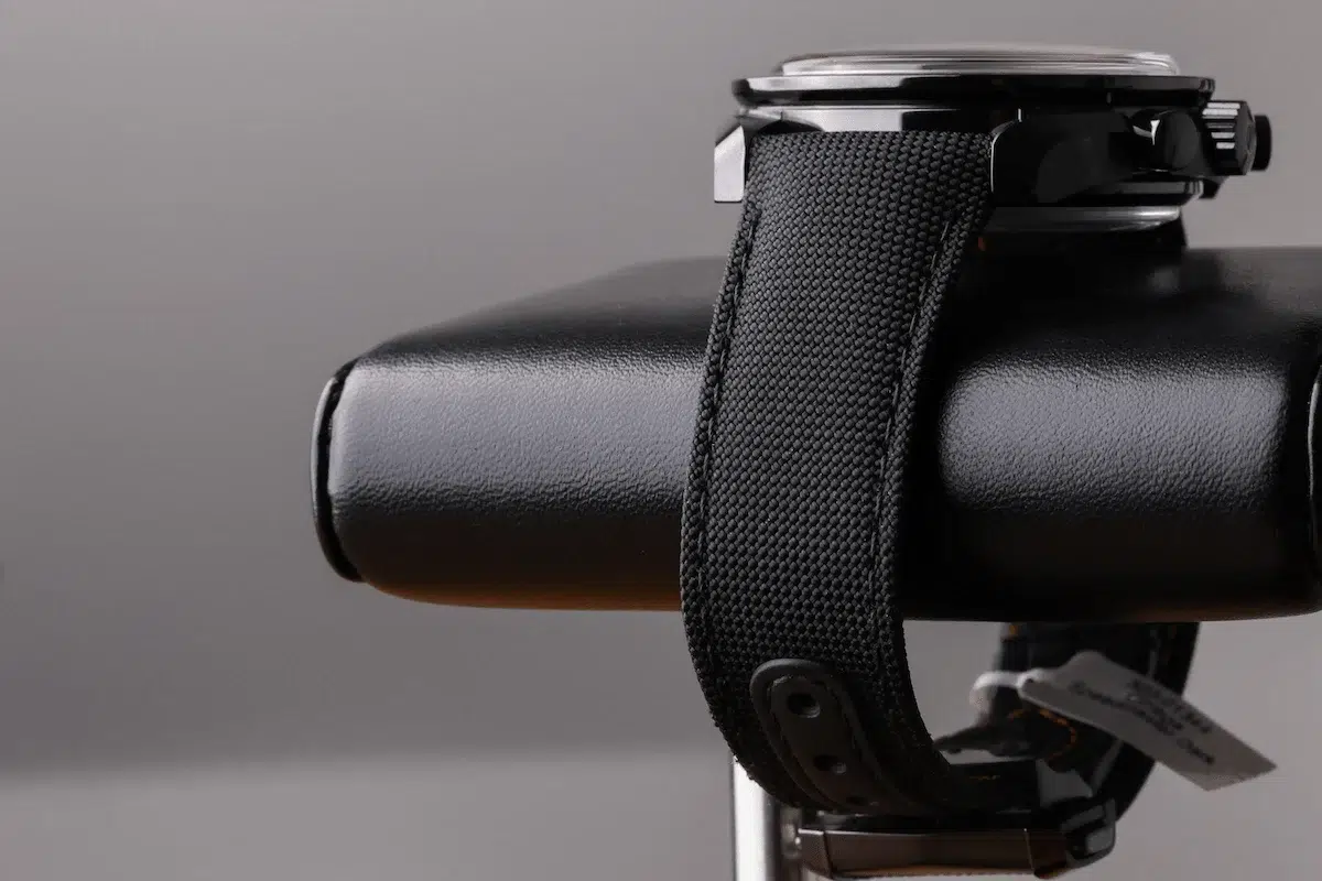 Side profile of Omega Speedmaster Dark Side of the Moon on black nylon strap