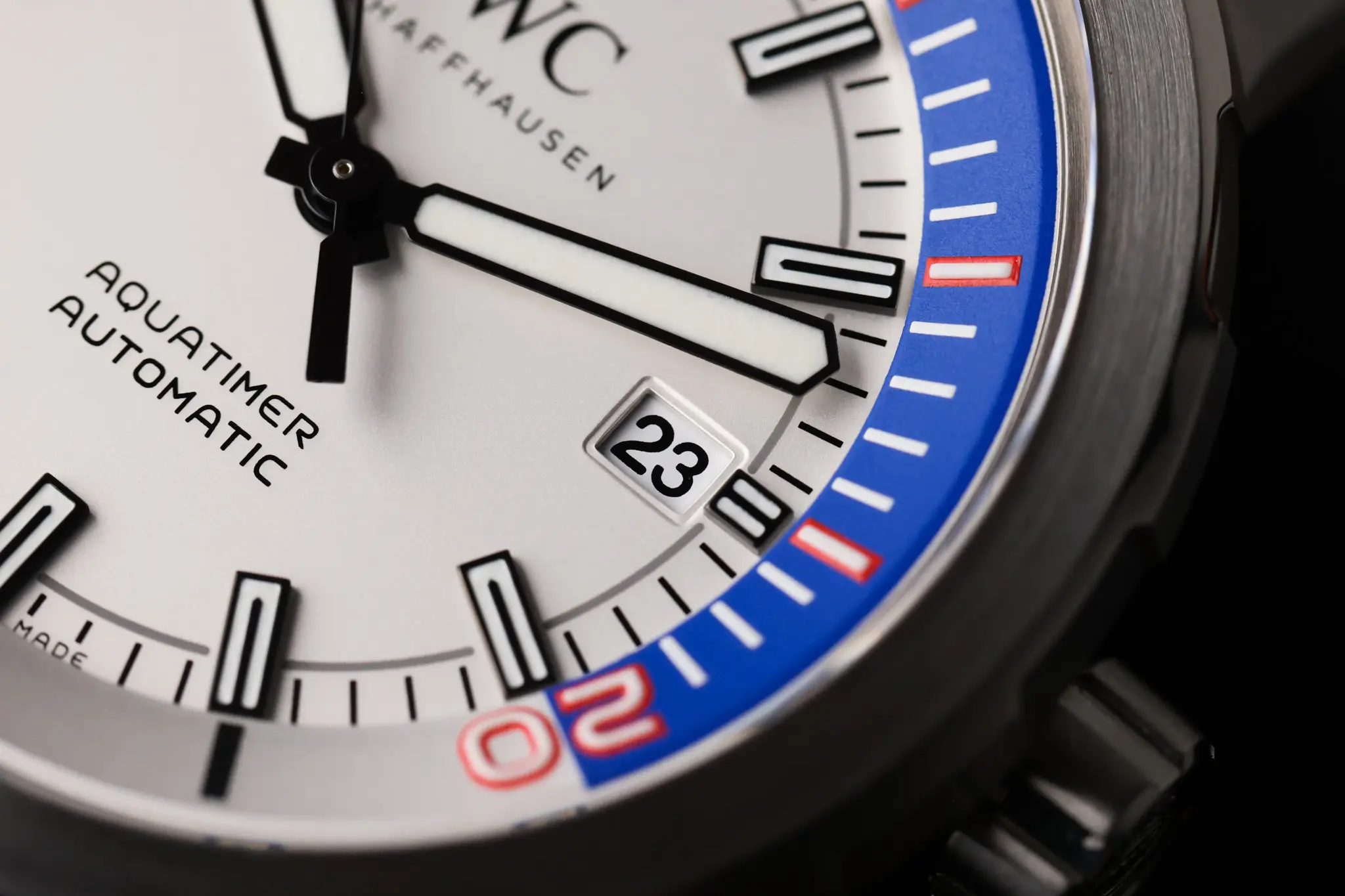 Close-up of the IWC Aquatimer internal rotating bezel with blue and red timing scale