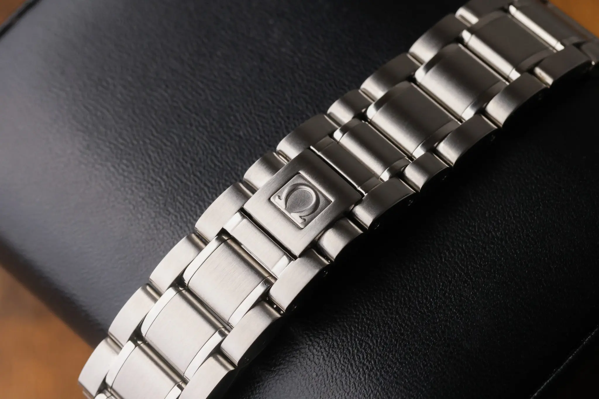 Close-up of the Omega Speedmaster Day Date bracelet links and clasp area