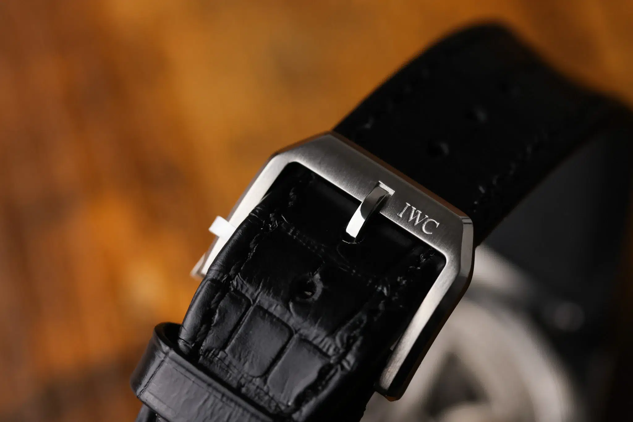IWC-signed stainless steel buckle on black leather strap