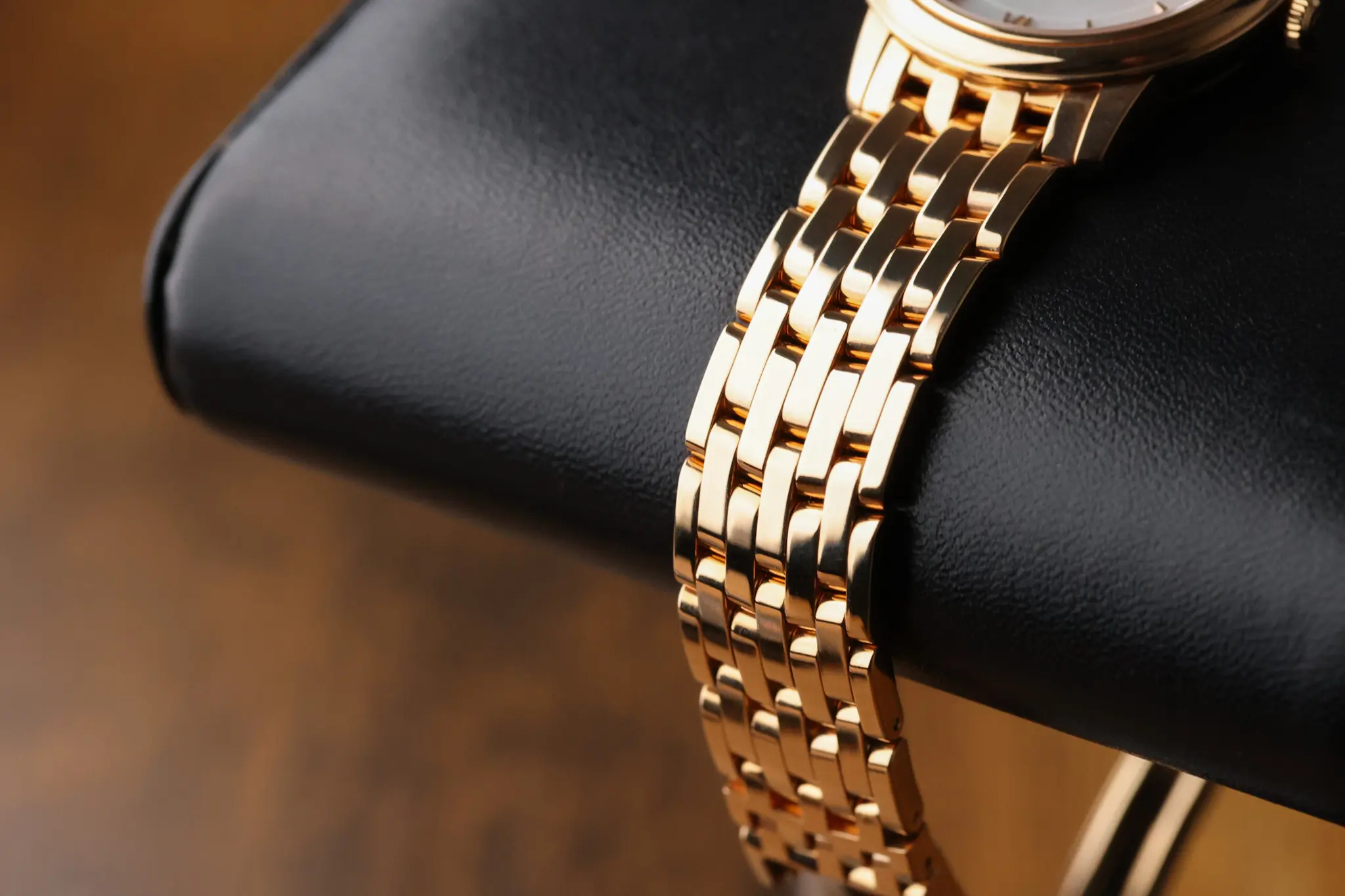 Omega De Ville Prestige 18K rose gold multi-link bracelet detail on wrist cushion