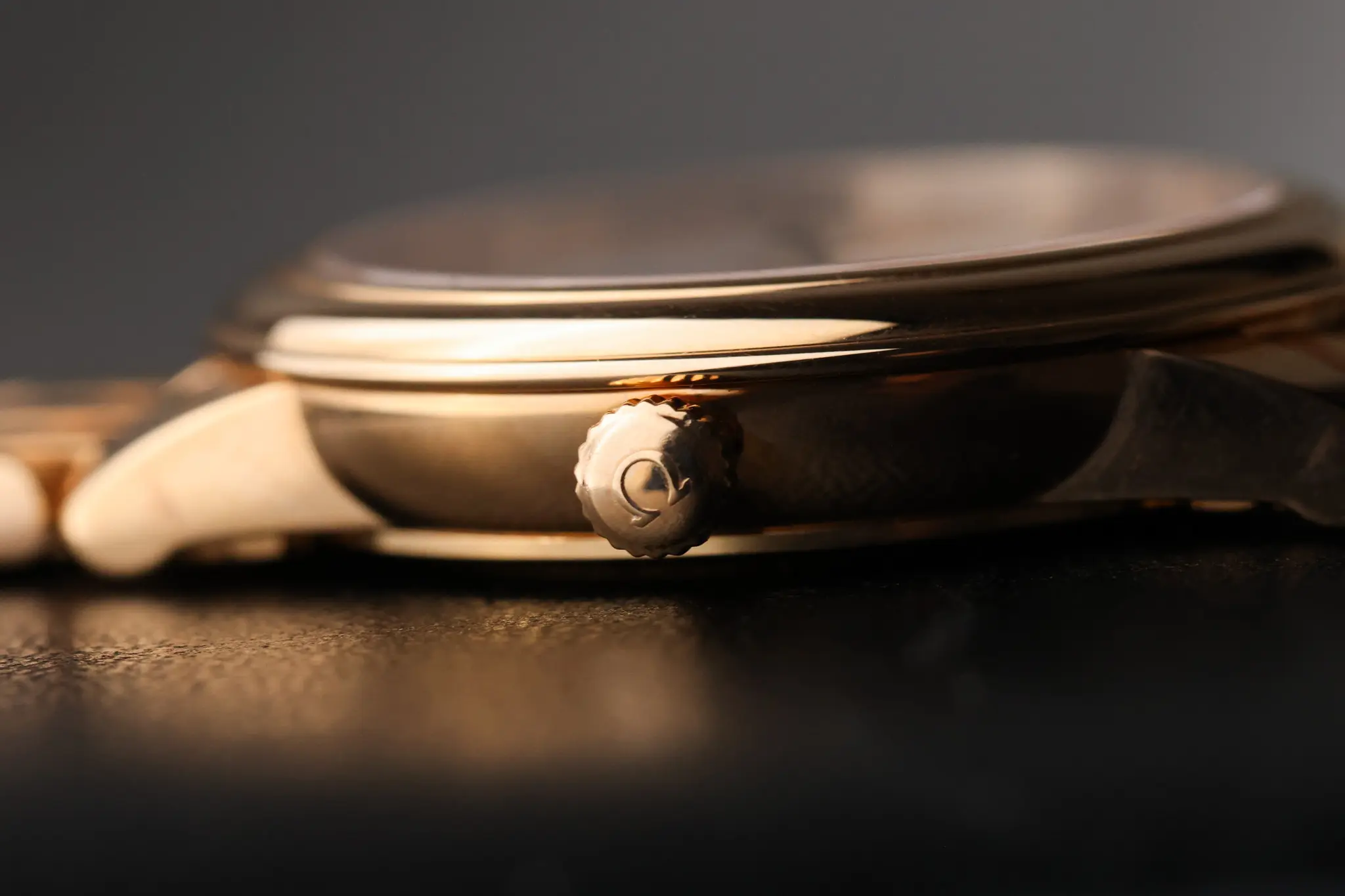 Side profile of Omega De Ville Prestige showing slim 27mm rose gold case and signed crown