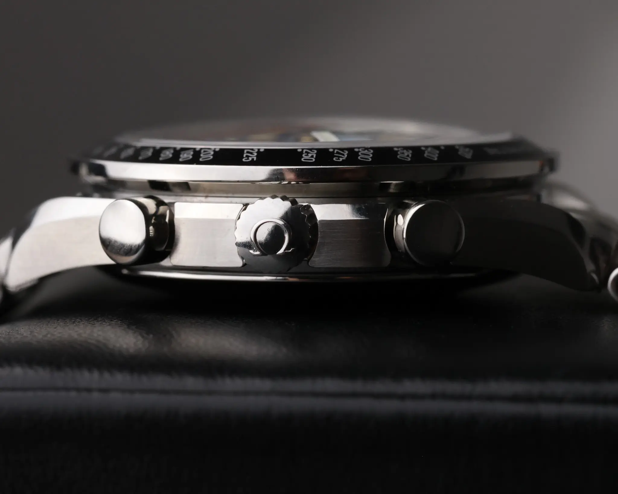 Side profile of the Omega Speedmaster Day Date case showing chronograph pushers