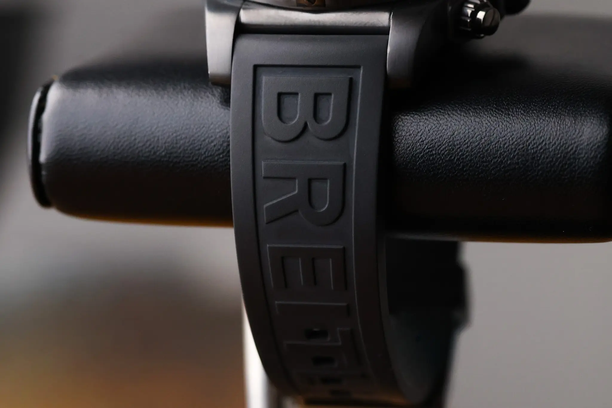 Close-up of Breitling logo embossed on the black rubber strap