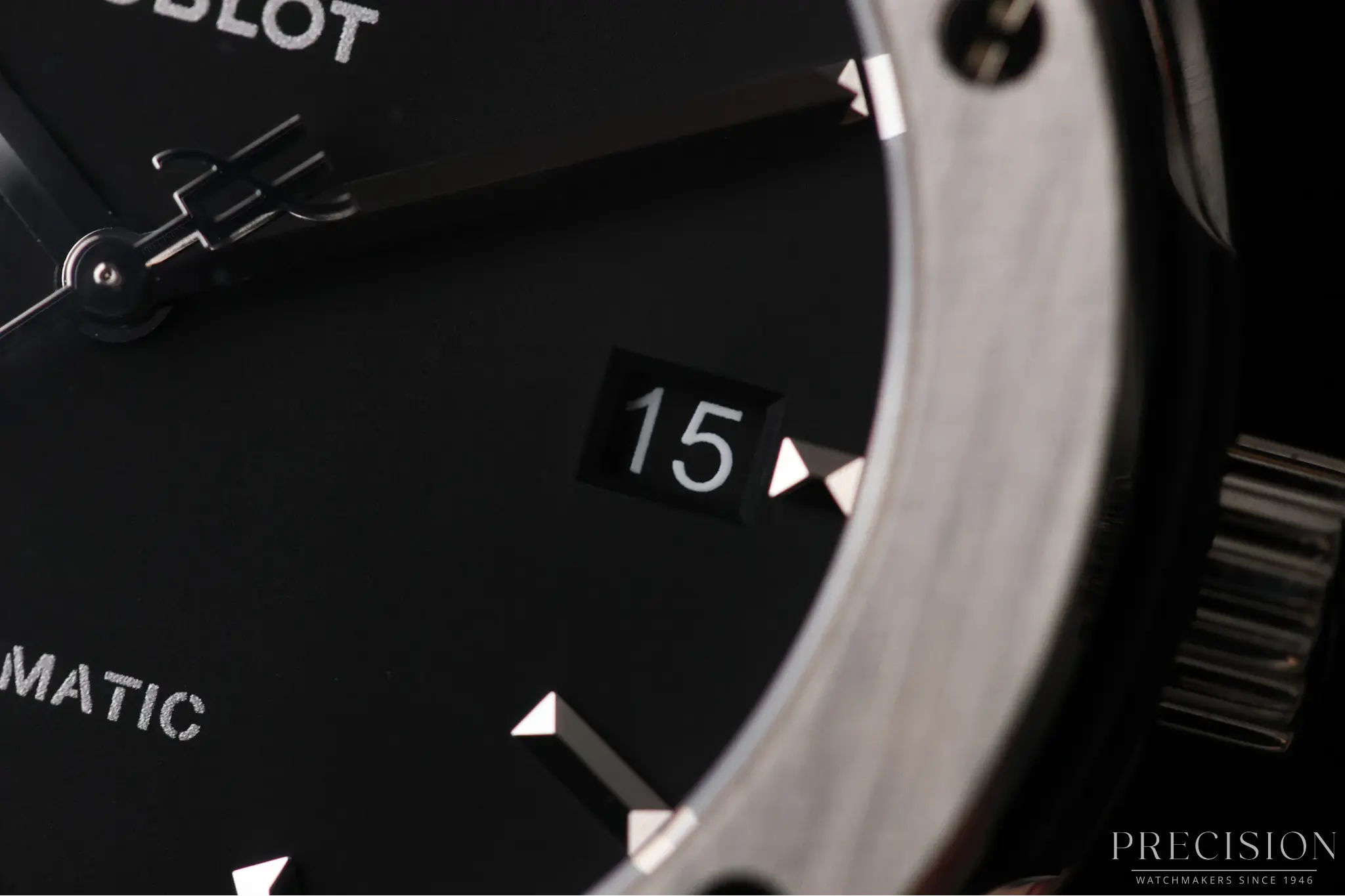 Close-up of Hublot Classic Fusion 45mm black dial with date window and titanium bezel screws