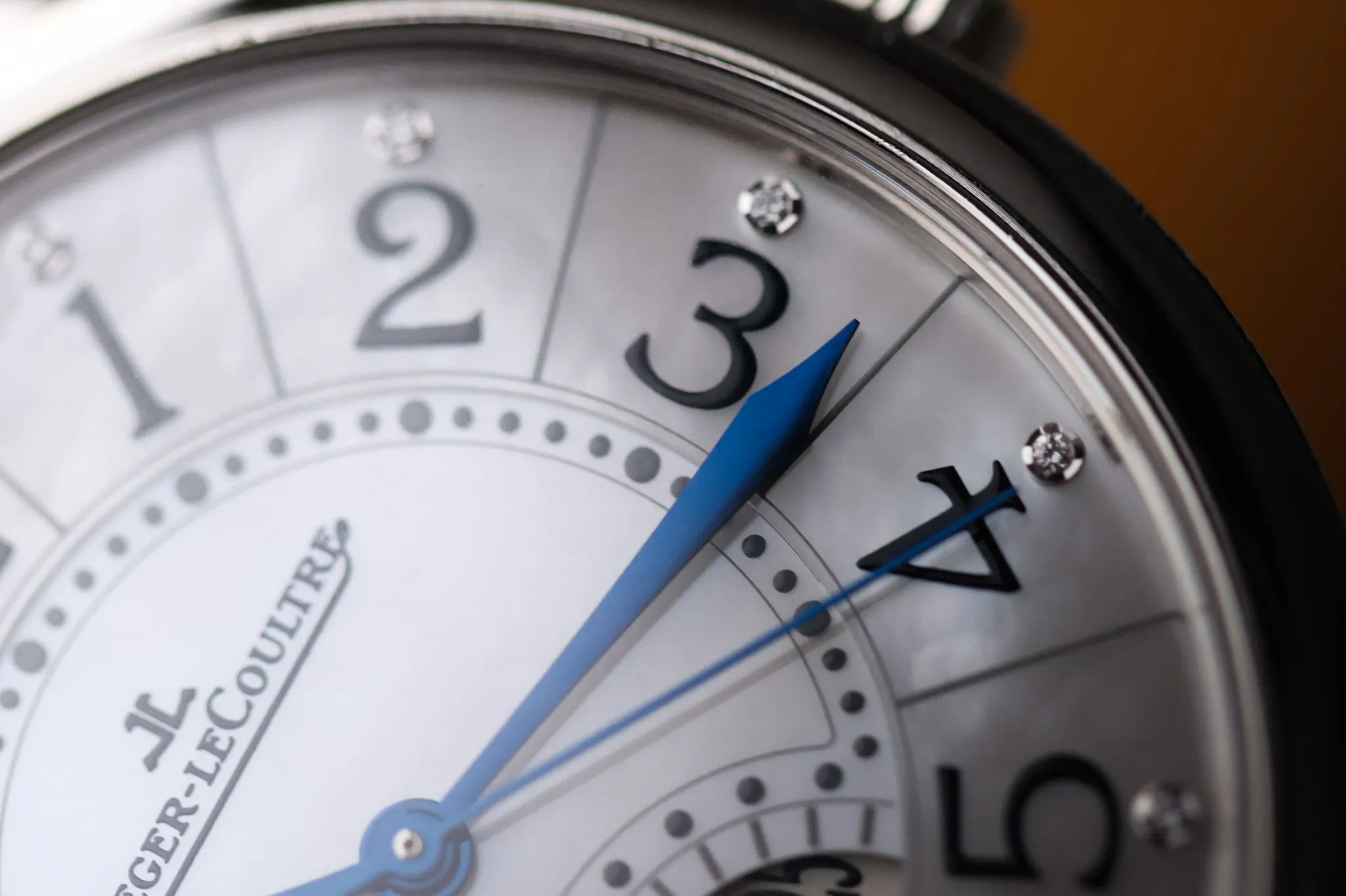 Macro detail of blued hands and Arabic numerals on Jaeger-LeCoultre Rendez-Vous Date watch