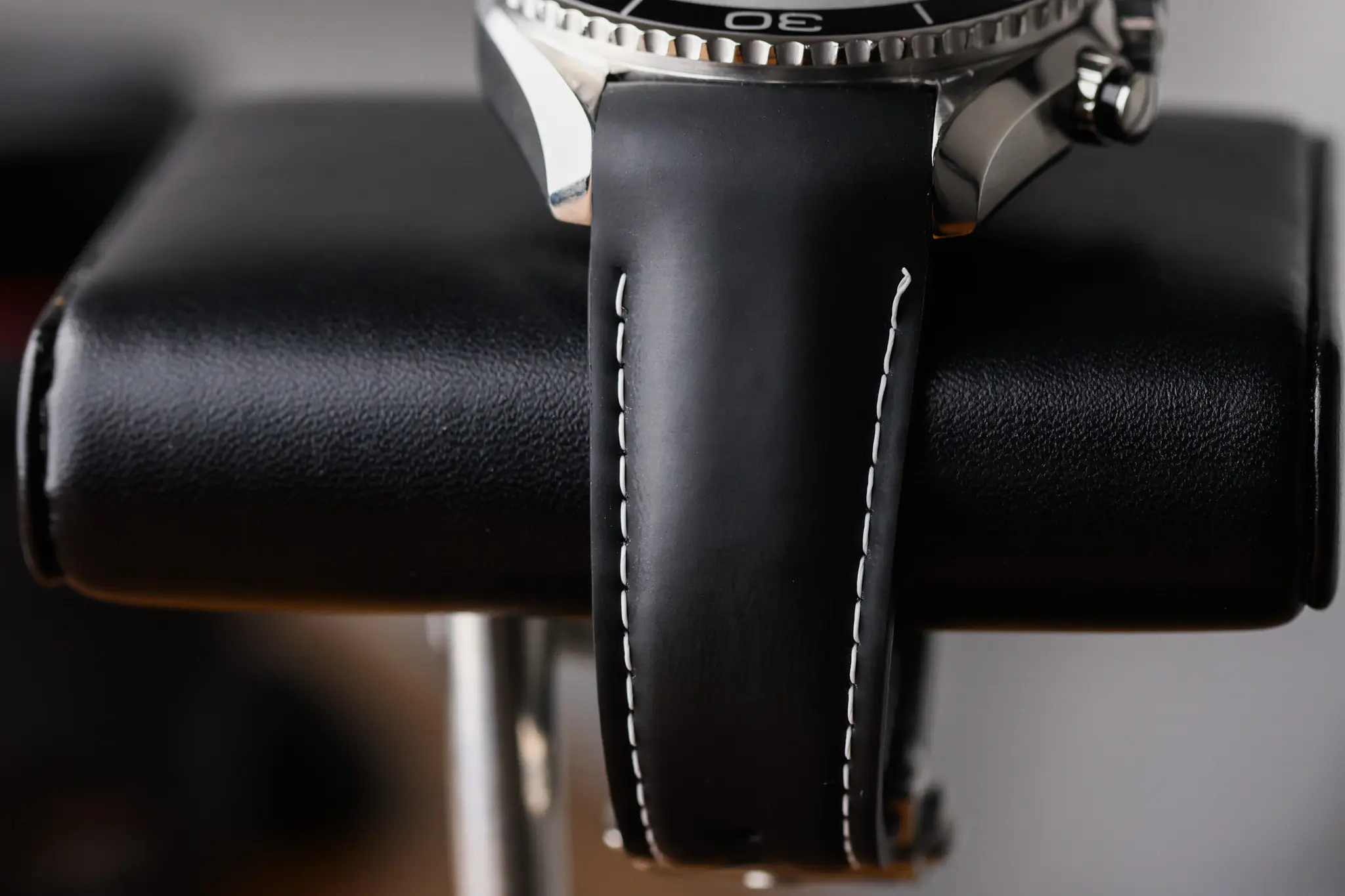 Side profile of Omega Seamaster Planet Ocean Olympic edition showing black leather strap and case thickness