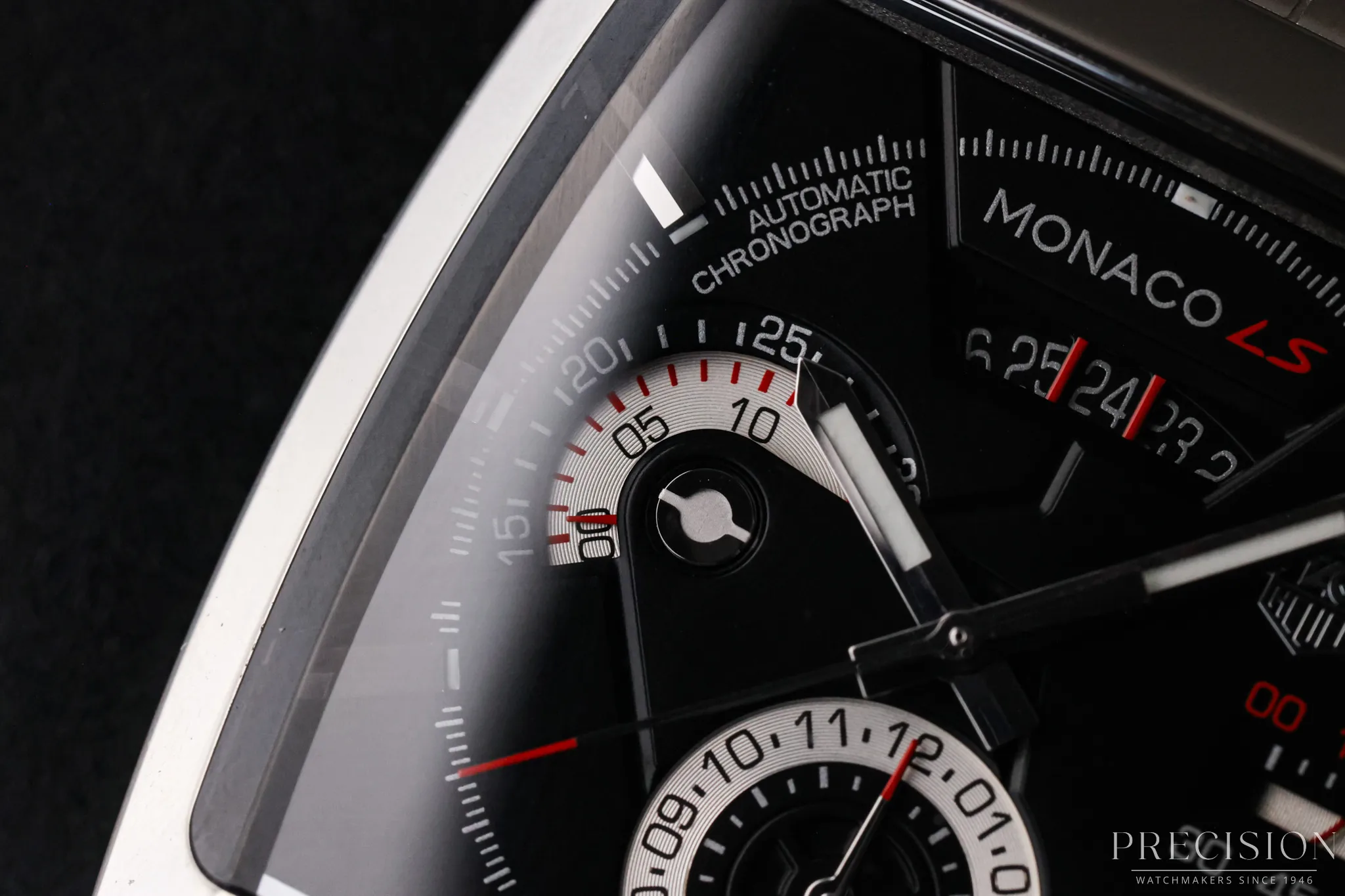 TAG Heuer Monaco LS dial detail with black chronograph layout and red Monaco LS accents