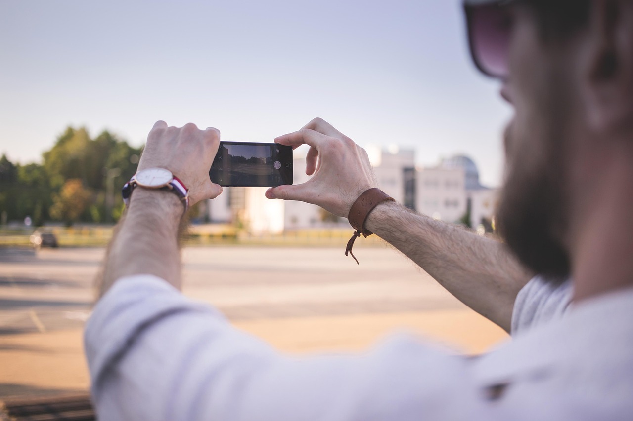 man wearing watch holding phone