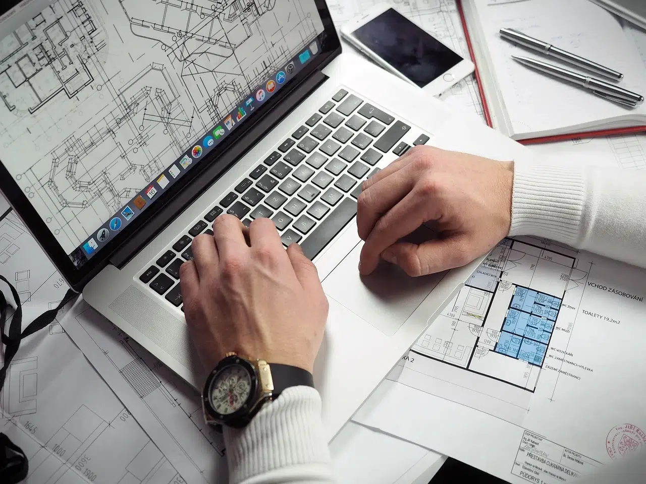 wearing a watch using a laptop