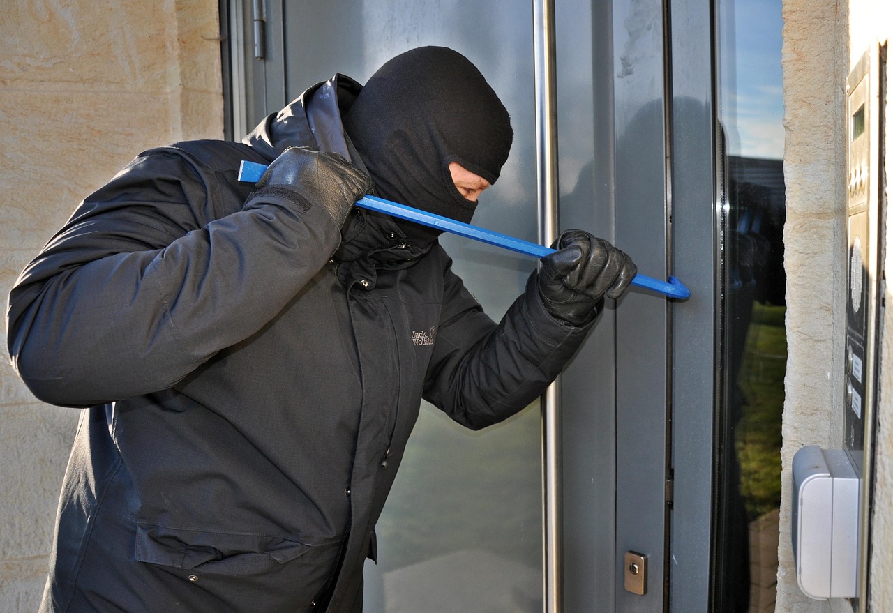 burglar breaking in with crow bar
