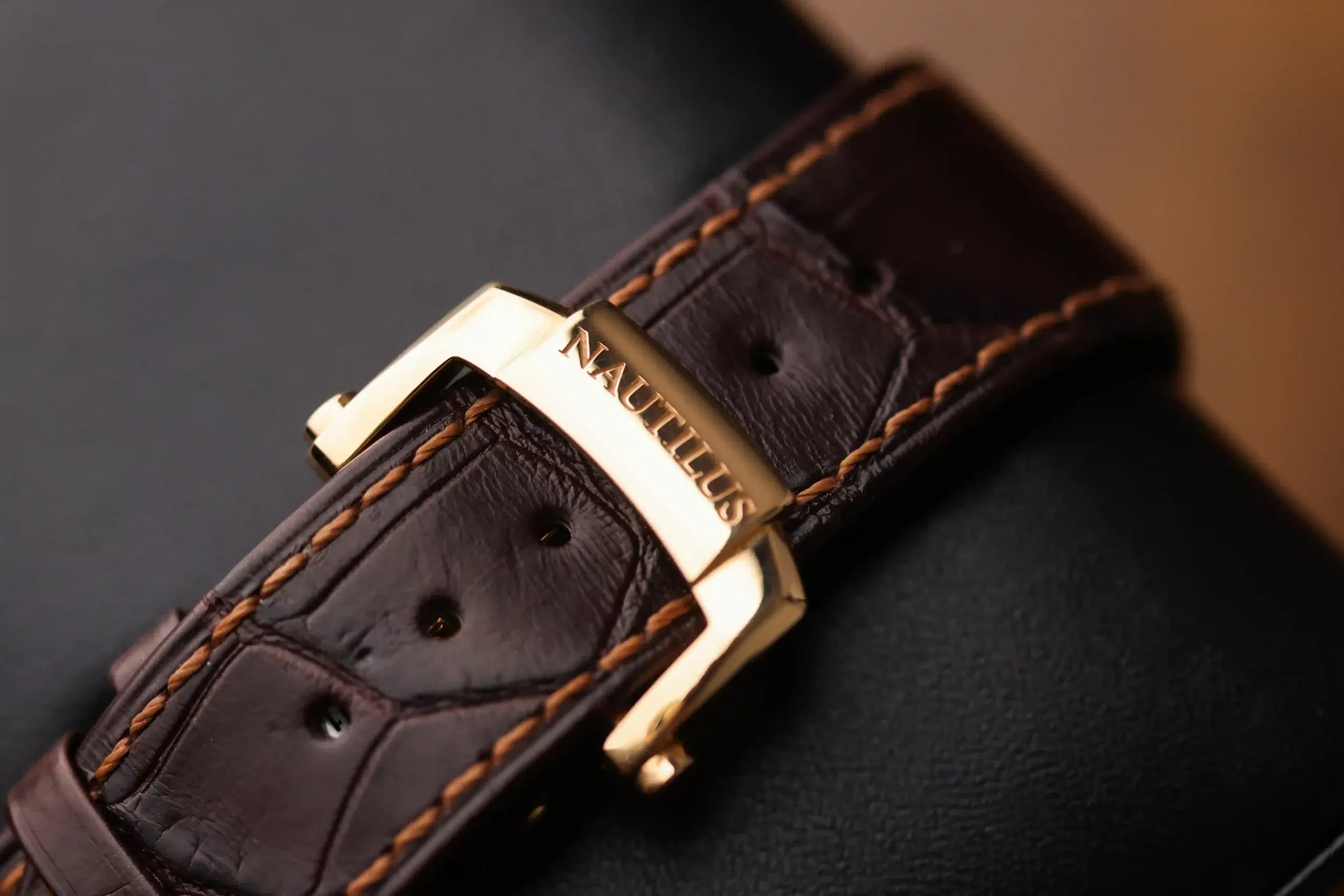 Brown leather strap and rose-gold buckle detail on the Patek Philippe Nautilus 5980R-001