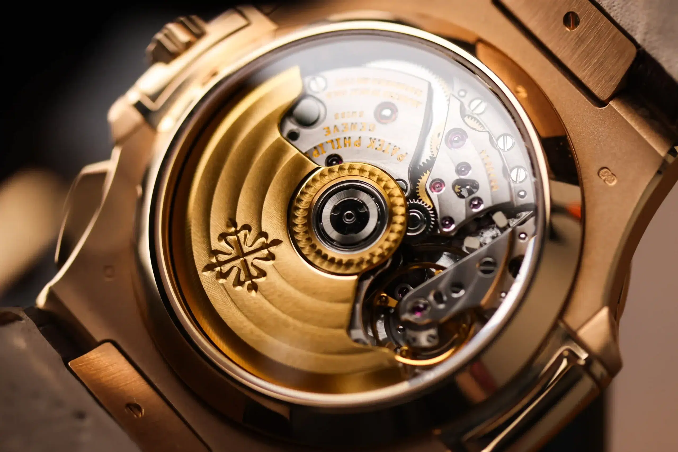 Exhibition caseback view of the Patek Philippe Nautilus 5980R-001 showing the automatic movement and gold rotor