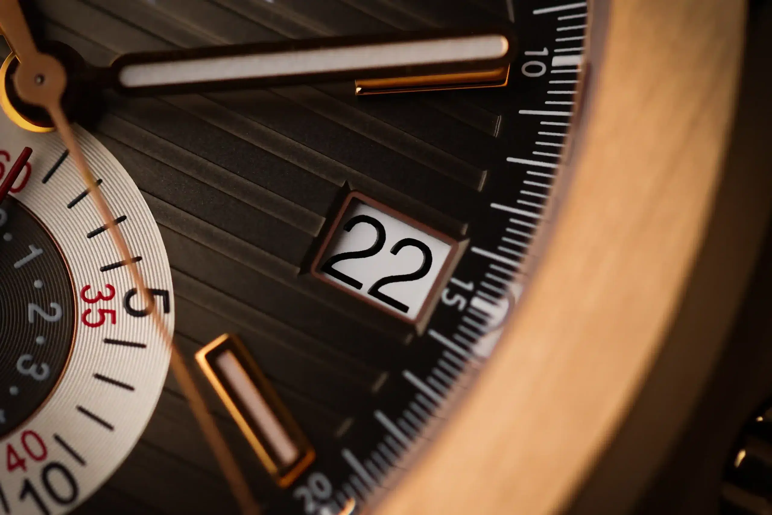 Macro detail of the rose-gold bezel, brown dial, and date window on the Patek Philippe Nautilus 5980R-001