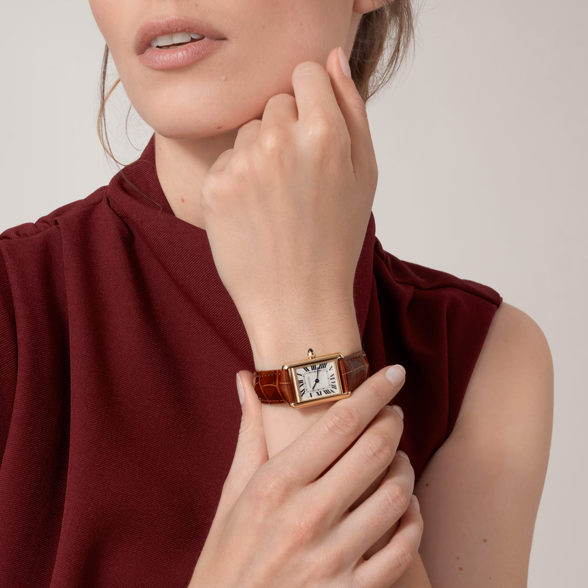 cartier tank worn on female wrist with leather strap