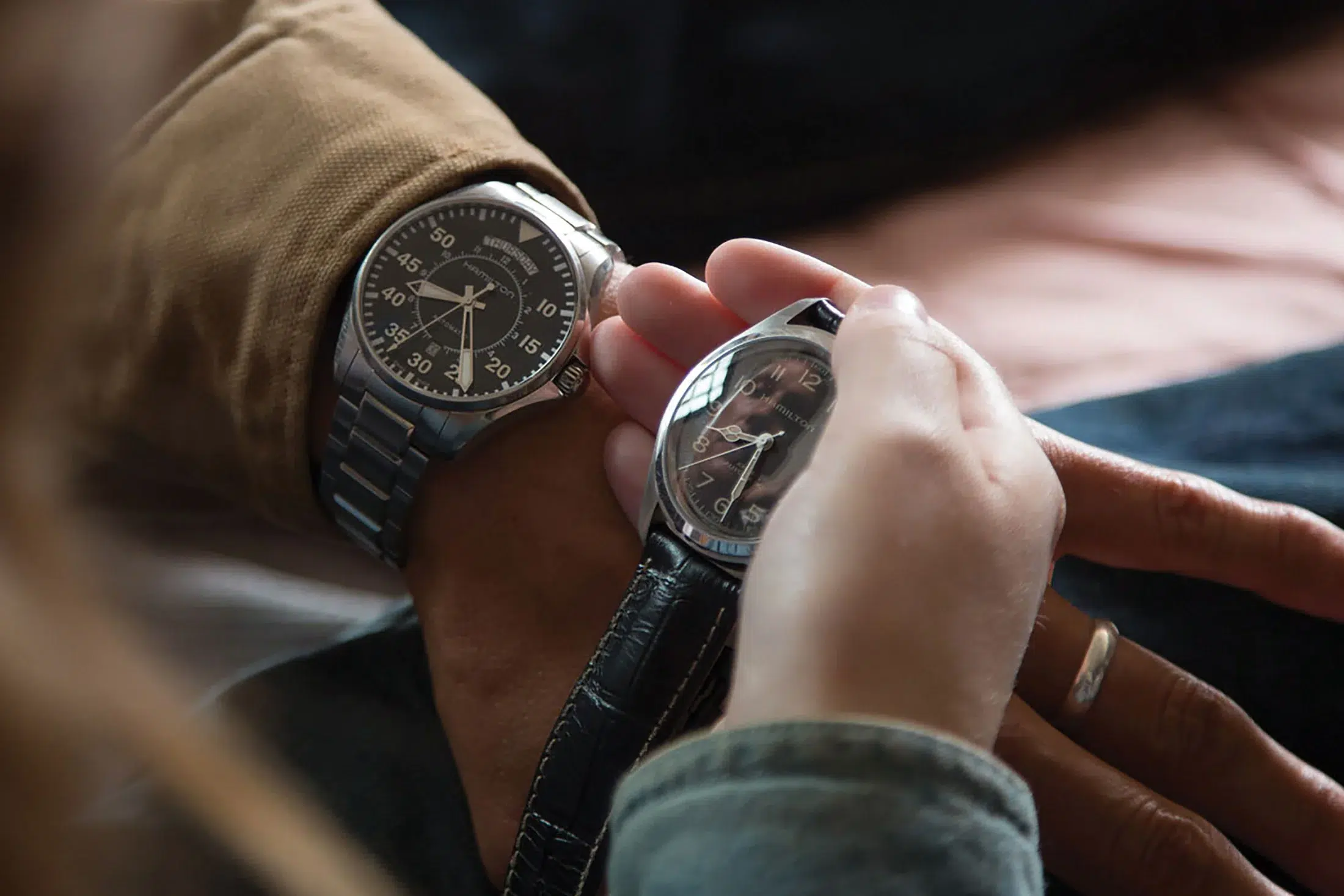 Screenshot from Interstellar showing two Hamilton watches side by side, with the Hamilton Murph on the right and the standard Khaki Aviation Pilot watch on the left.