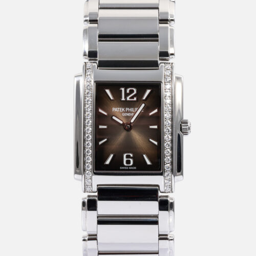 Front view of a pre-owned Patek Philippe Twenty~4 (Ref. 4910/1200A-010) in stainless steel, featuring its rectangular diamond-set bezel, sunburst gray dial with black-gradient rim, white gold applied Arabic numerals and trapeze indices, and integrated cambered steel bracelet.