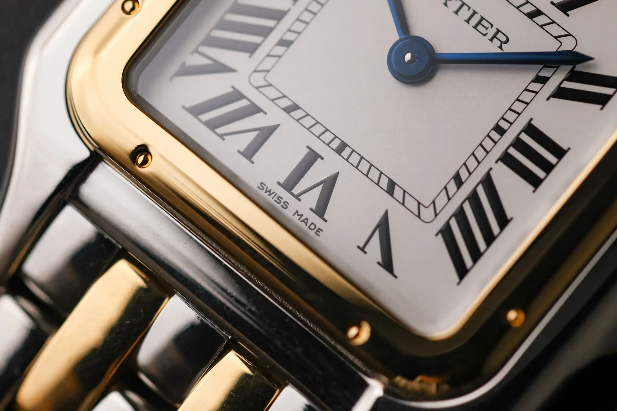 Close-up of two-tone Cartier Panthère case and bracelet showing dial corner and bracelet links