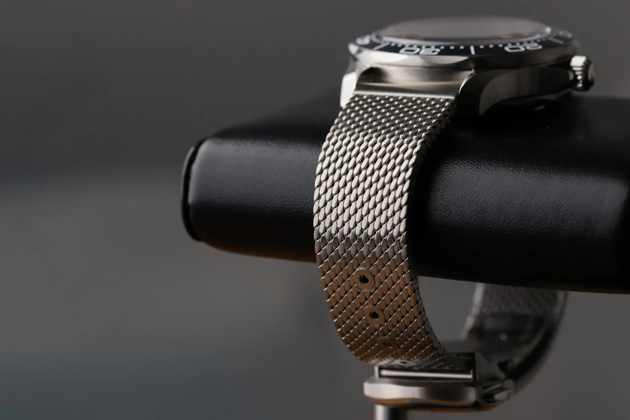 Omega Seamaster James Bond 60th Anniversary stainless steel mesh bracelet on wrist stand