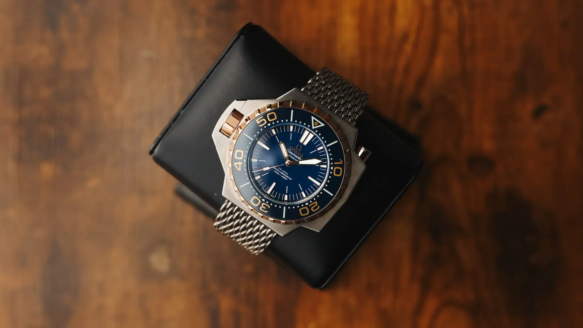 Omega Seamaster Ploprof 55mm Titanium and Rose Gold on display pillow