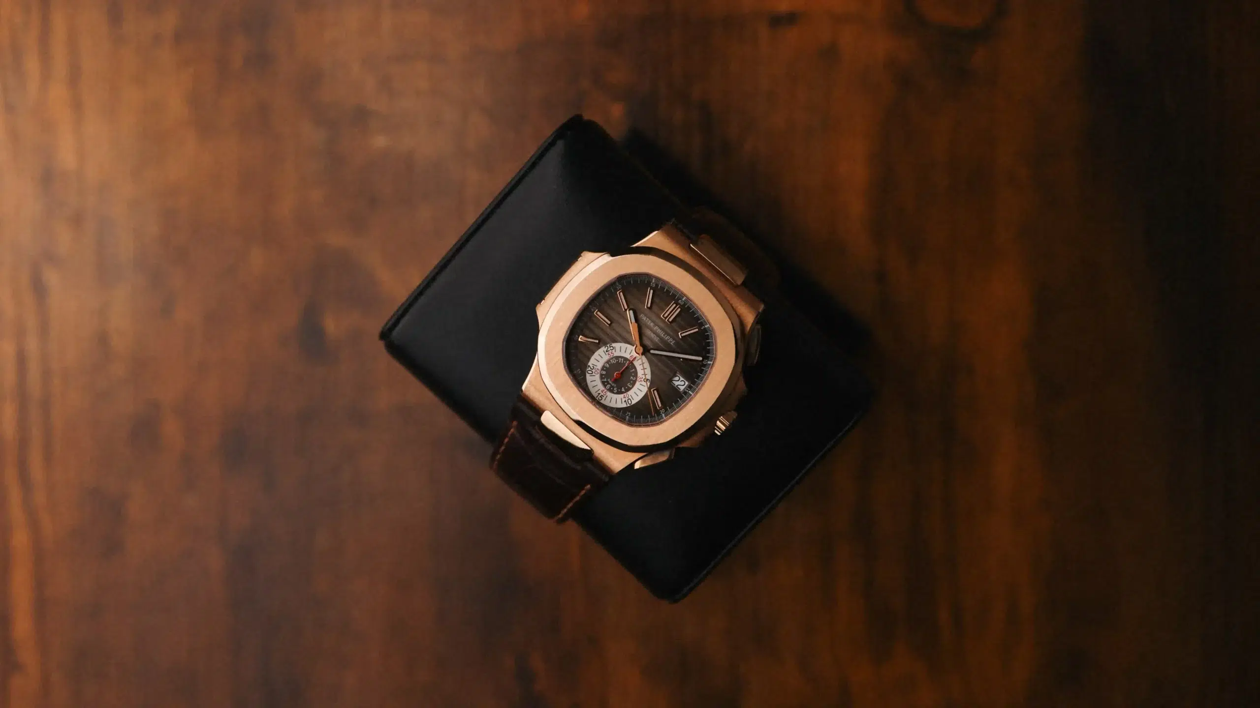 Patek Philippe Nautilus Chronograph 5980R-001 in rose gold photographed from above on a dark cushion
